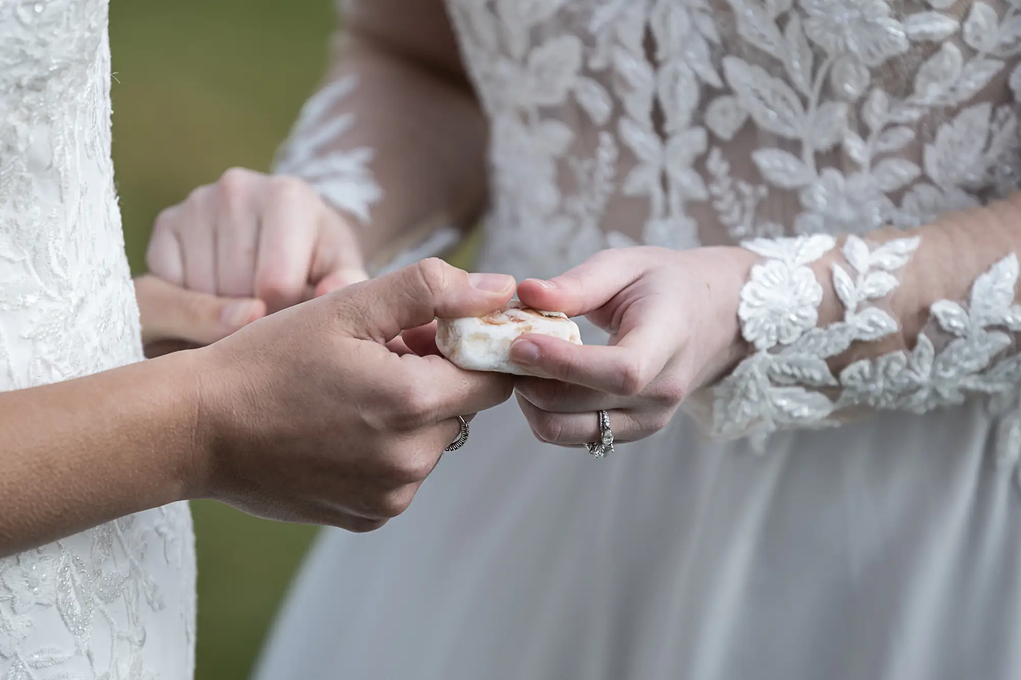 couple holding stone during marriage vows