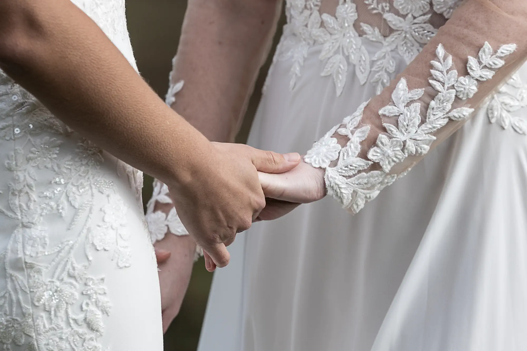girls holding hands as they exchange vows