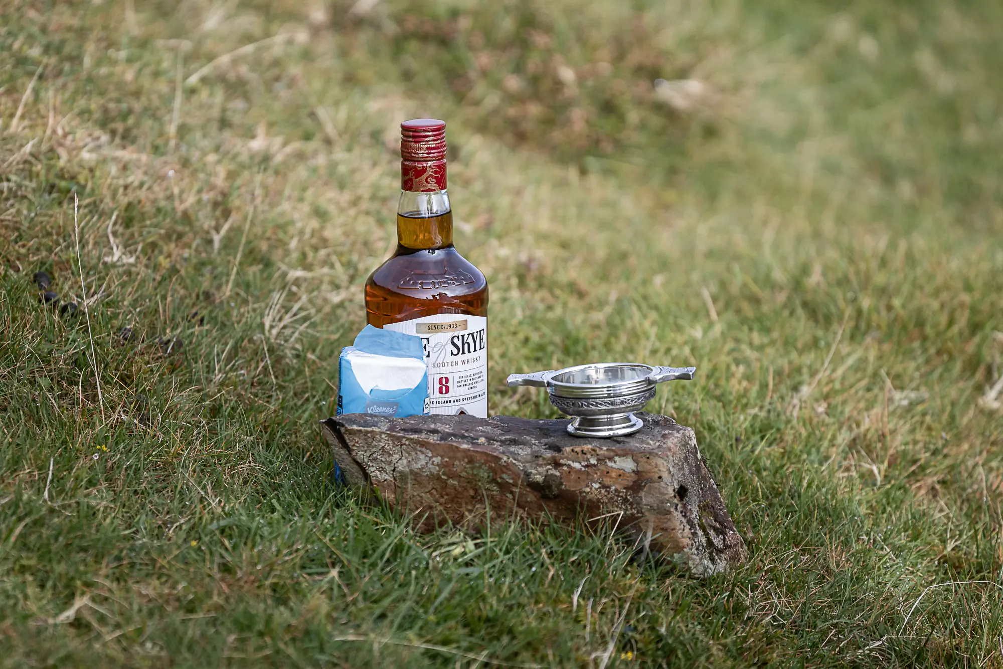 whisky and quaich on a hillside
