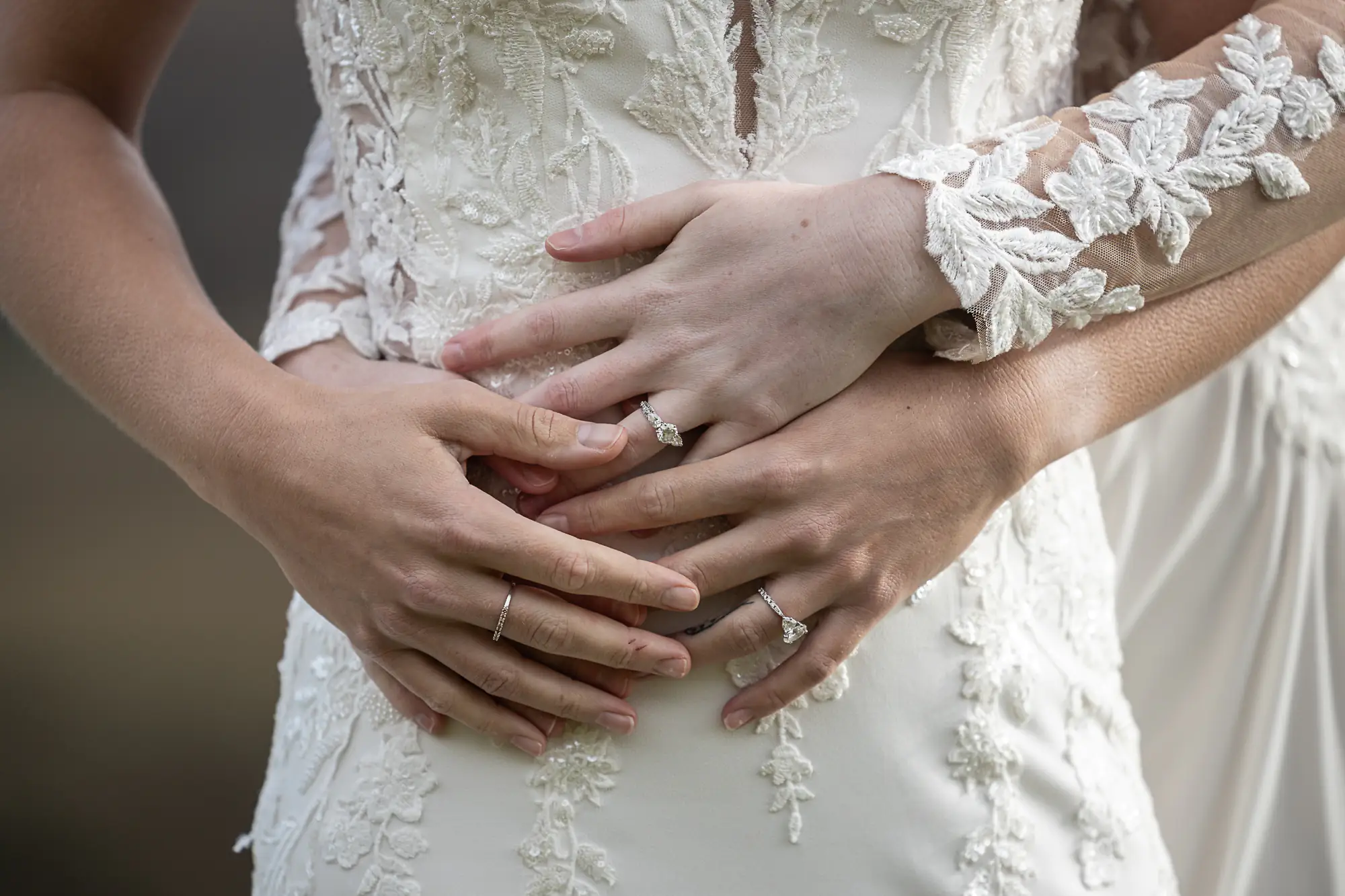 close up hands of newlywed brides