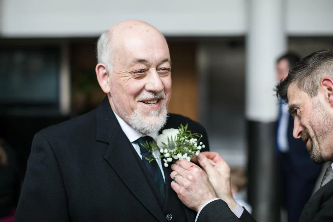 father of the groom has wedding buttonhole fitted