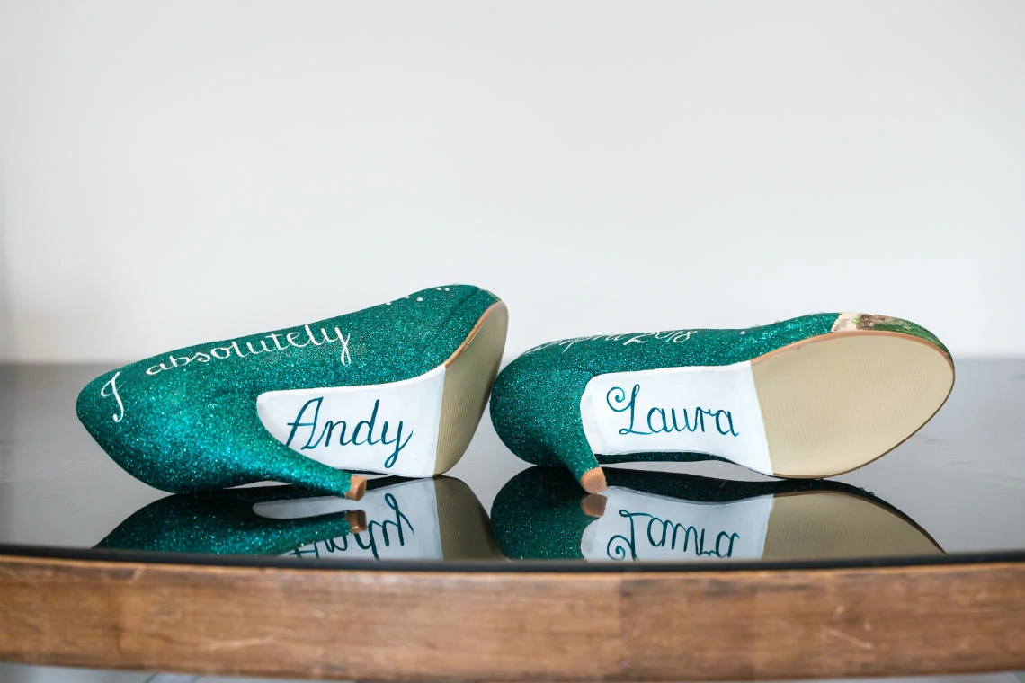 dark green bridal shoes with bride and groom's names on the soles