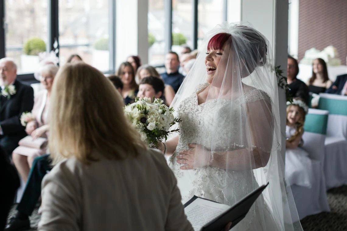 bride laughing as she arrives for the ceremony
