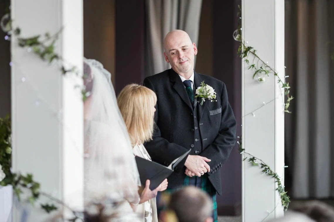 groom listens to the celebrant during Humanist ceremony