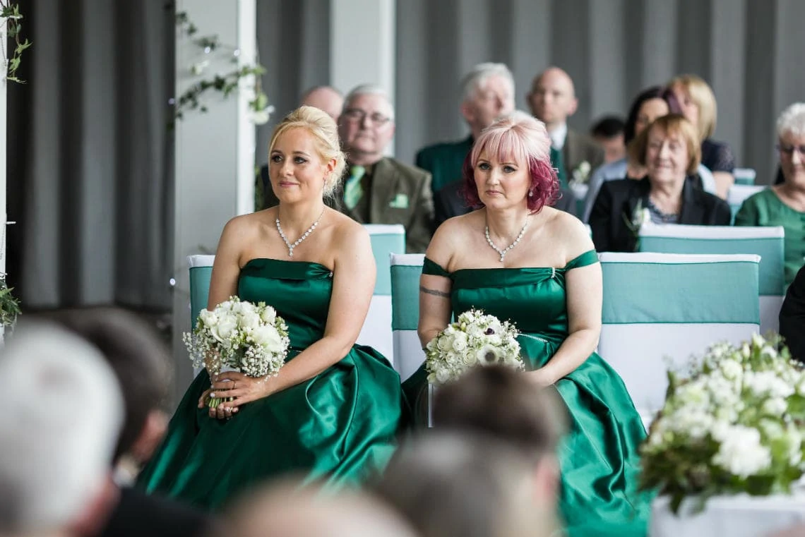 bridesmaids seated watching the ceremony