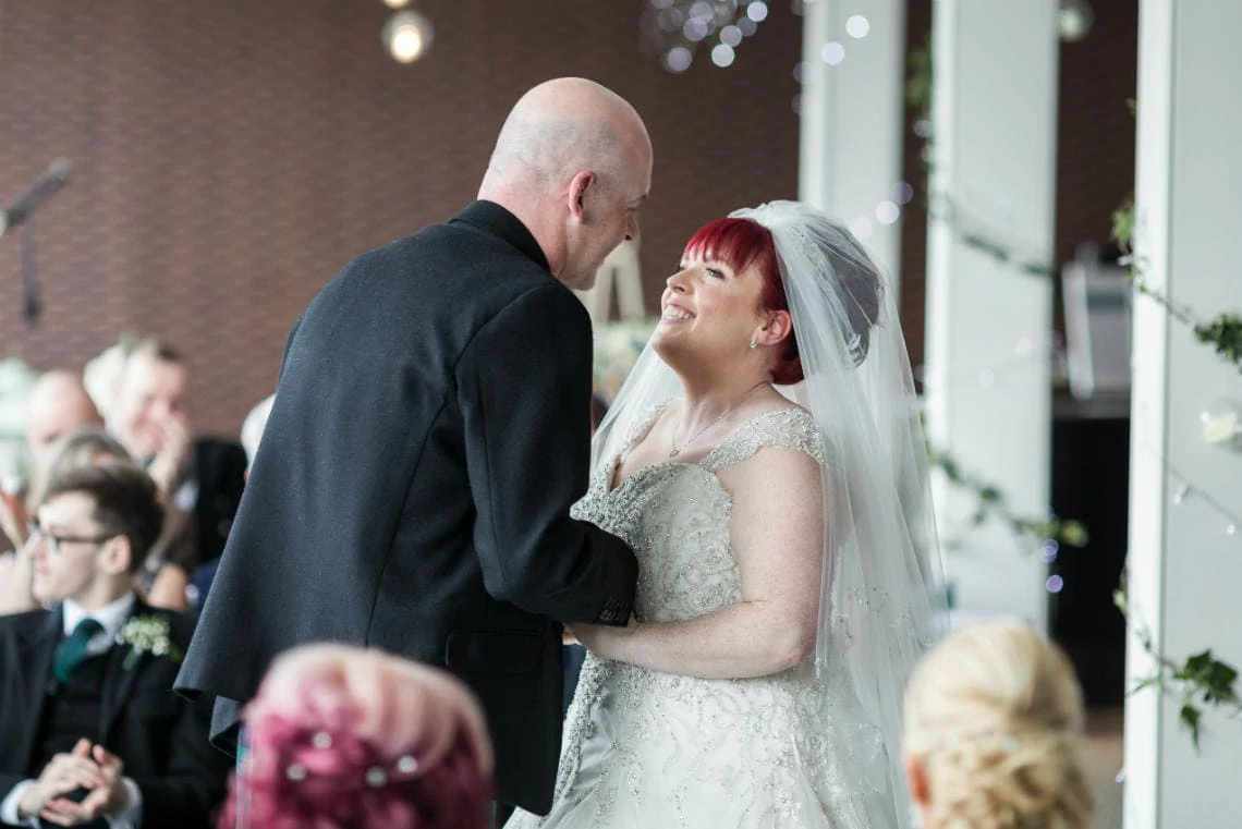 newlyweds smile at each other after their first kiss