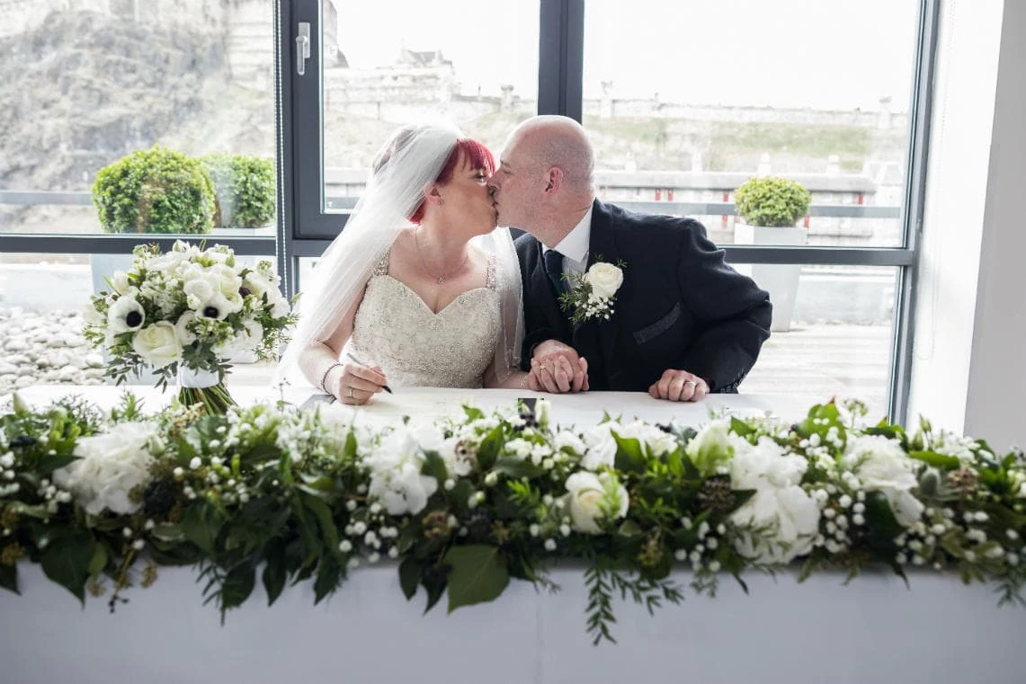 newlyweds kiss during signing of the schedule