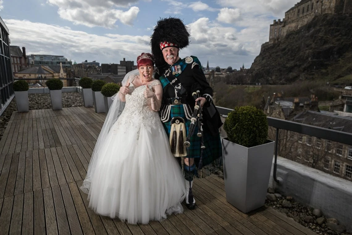 bride and Piper Jimmy Nicol standing on the balcony outside Heights restaurant