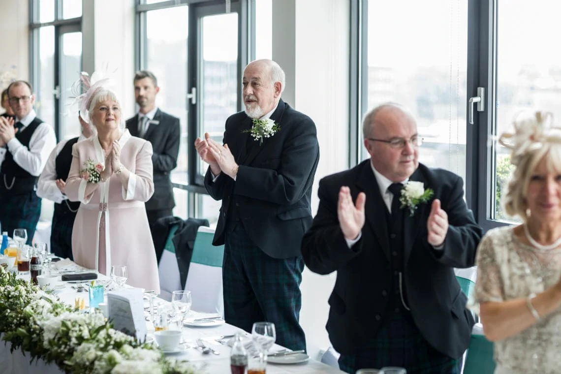 wedding party clapping at top table
