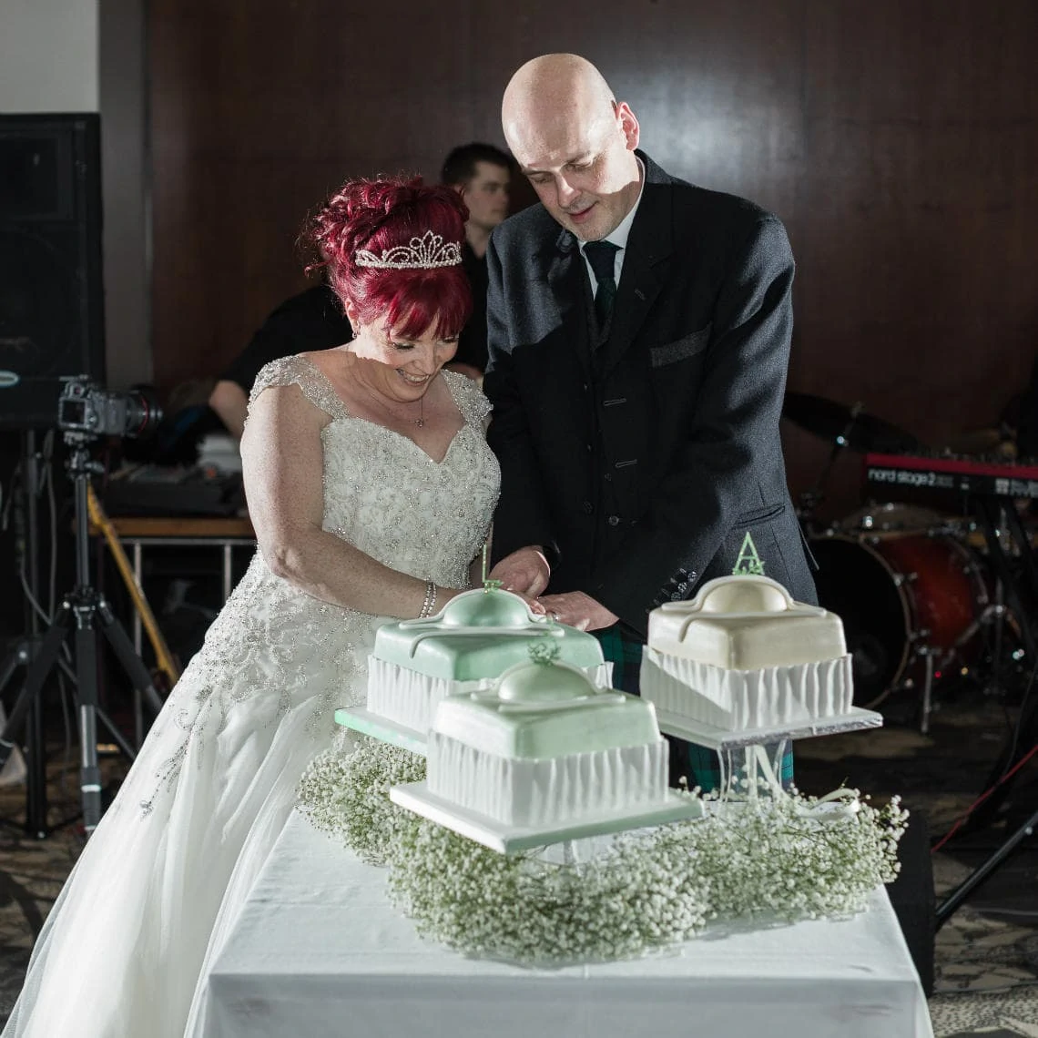 newlyweds cutting their wedding cake
