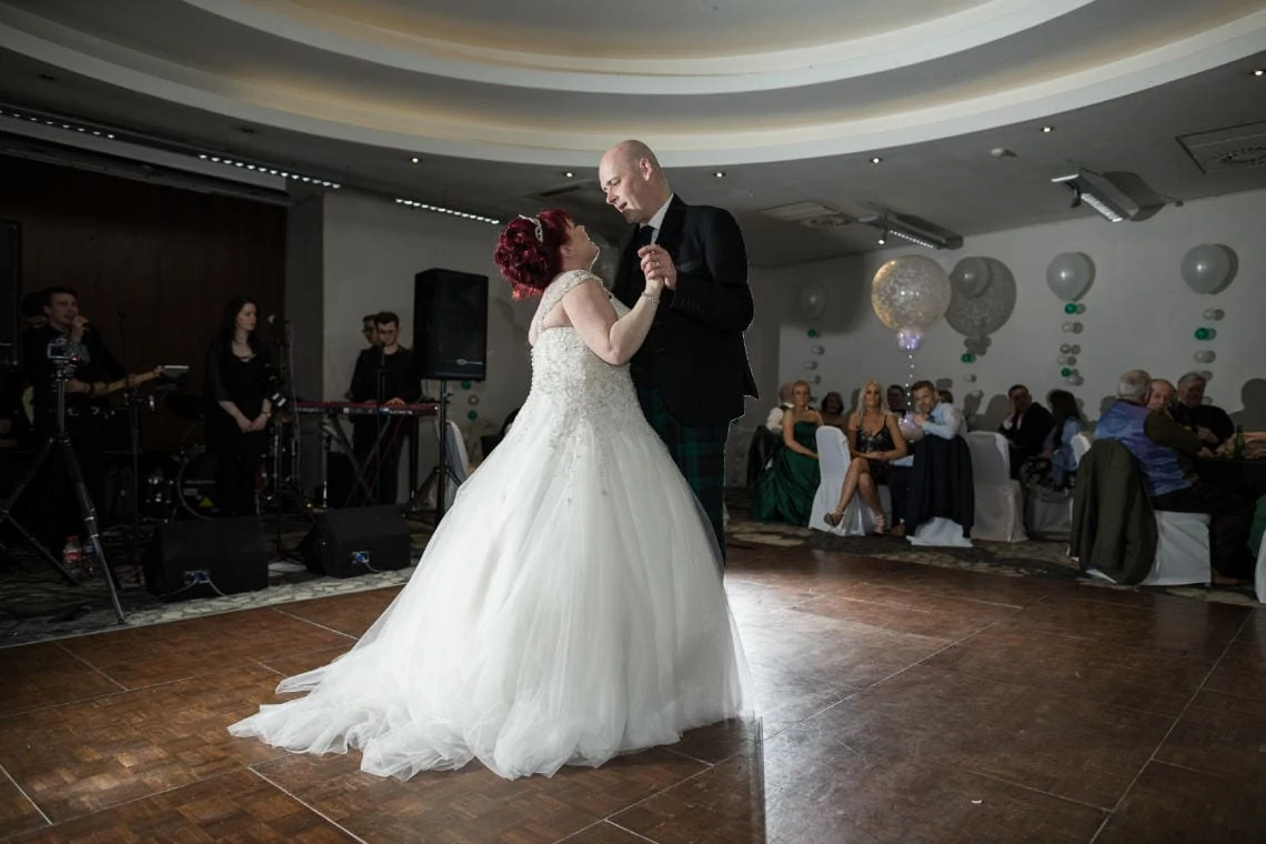 newlyweds first dance together at wedding reception