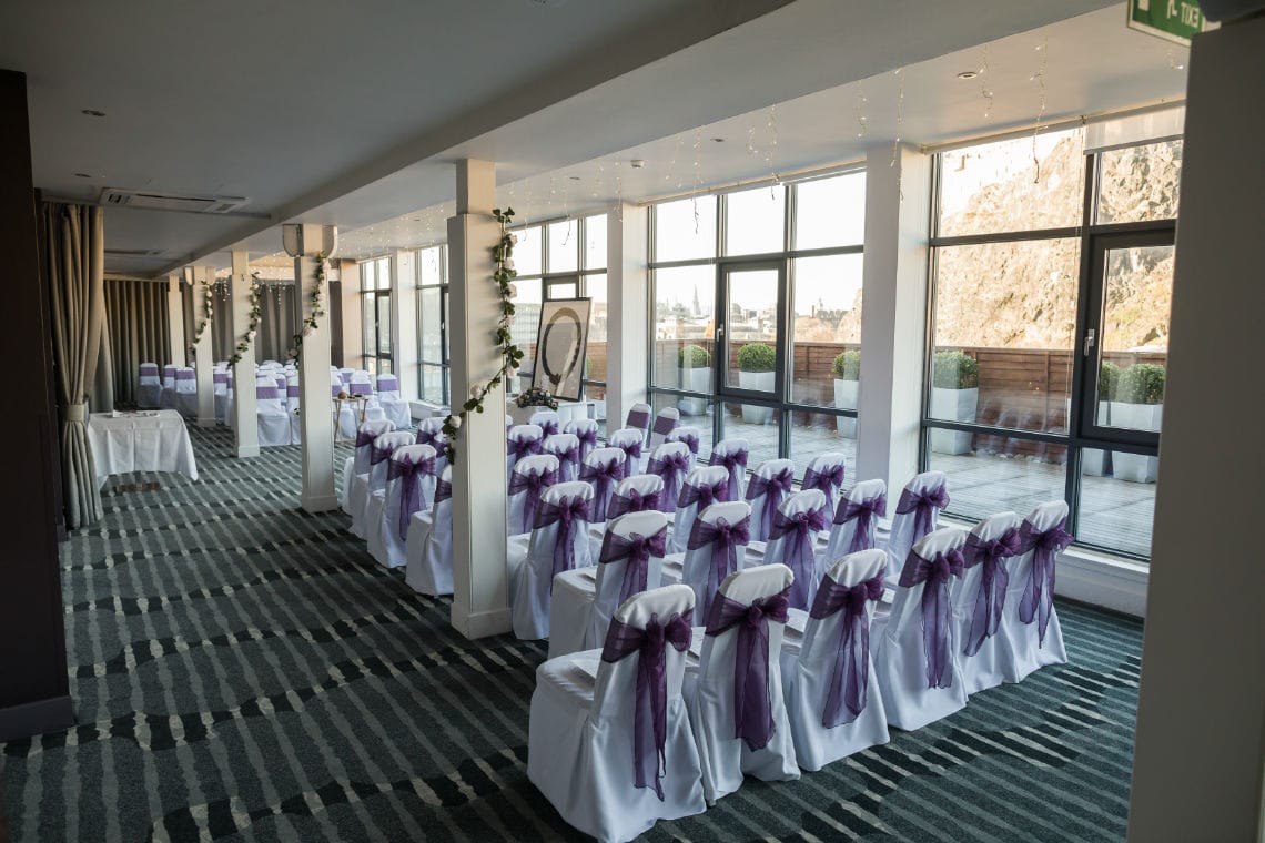 white chairs with purple organza in in Heights Restaurant