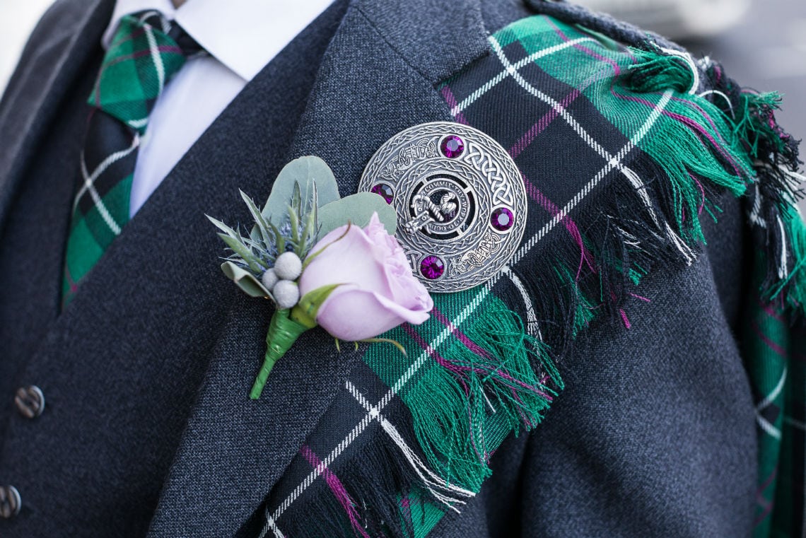 detailed photo of groom's buttonhole on suit jacket lapel