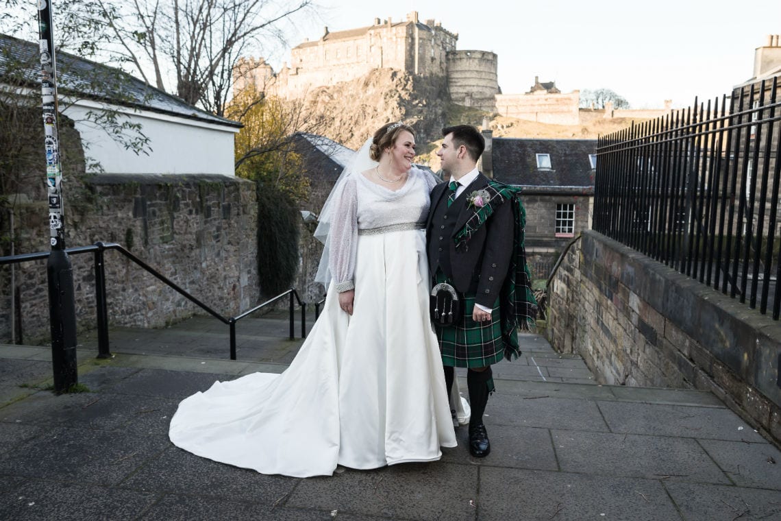 photo of the newlyweds taken at The Vennel with Edinburgh Castle in the background taken at The Vennel