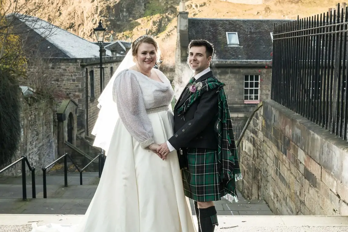 close up portrait photo of bride and groom taken at The Vennel in Edinburgh with Edinburgh Castle in the background