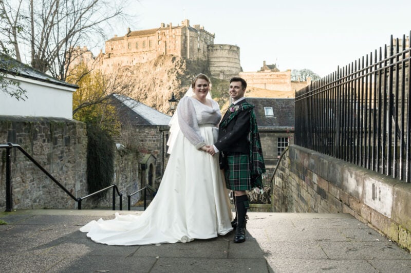 bride and groom photographed at The Vennel with Edinburgh Castle in the distance