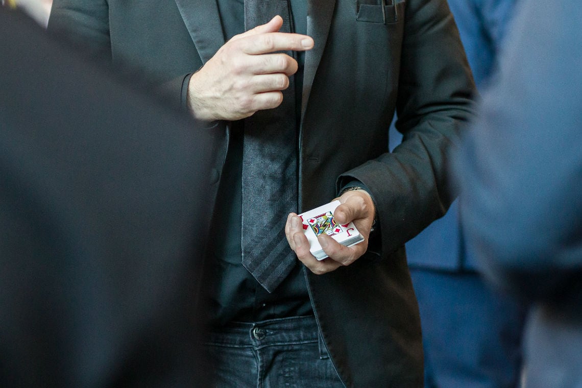 close up shot of magician holding a pack of playing cards