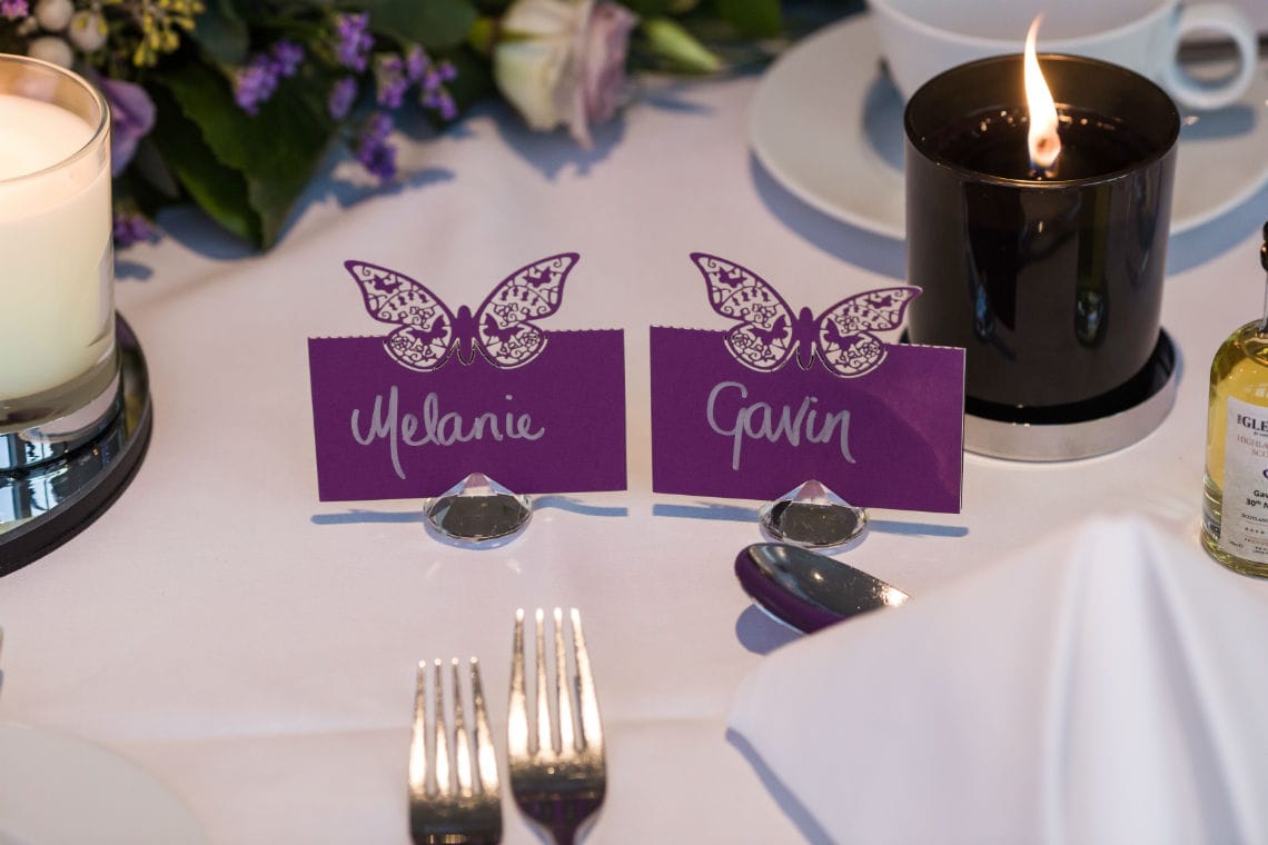 bride and groom's purple butterfly pace cards