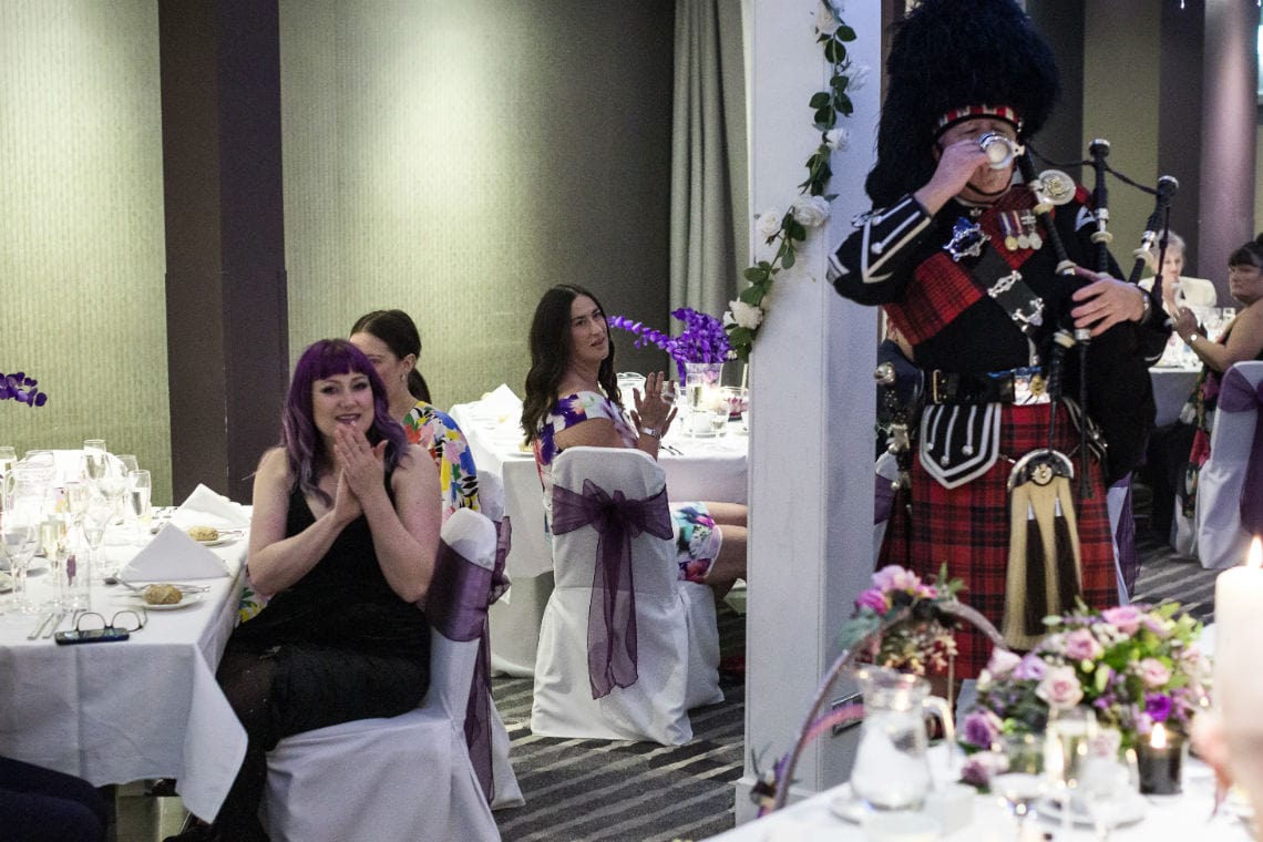 guests clapping as piper drinks a dram
