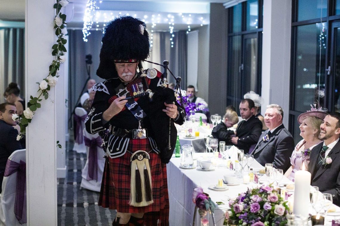 Pipe Major James Nicholl toasts the newlyweds