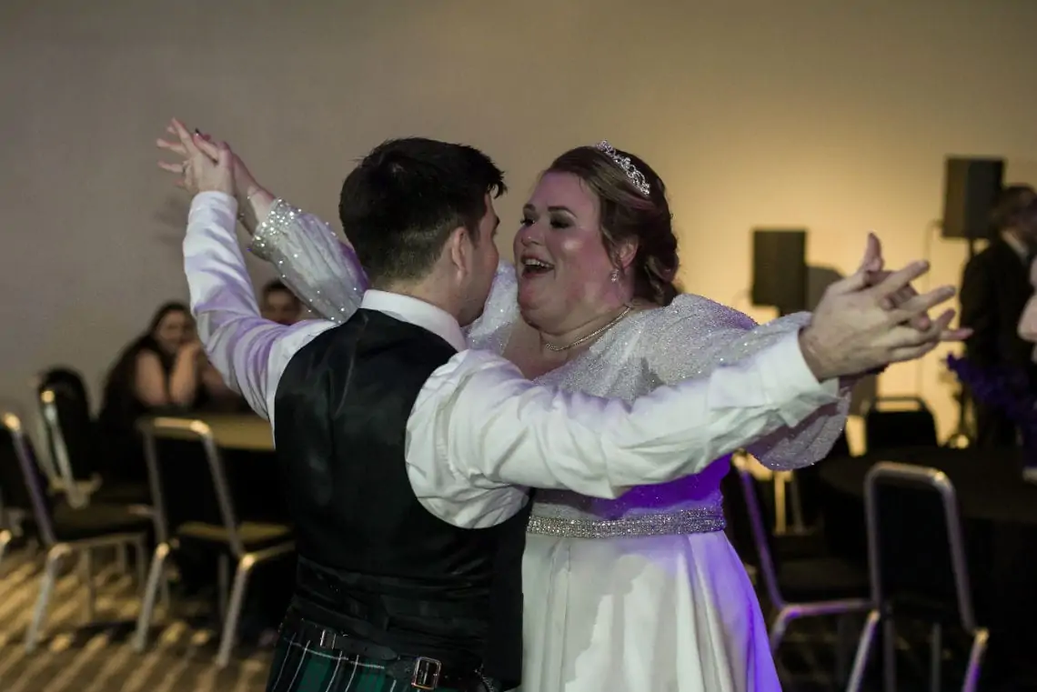 newlyweds smiling as they dance