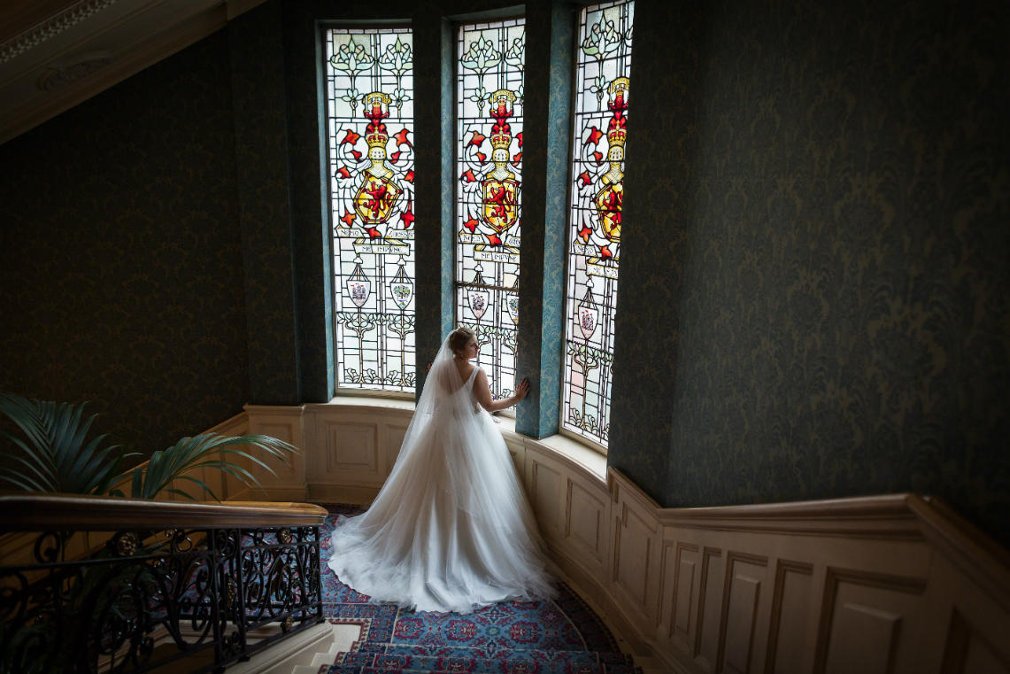 Staircase - bride in front of the stained glass window