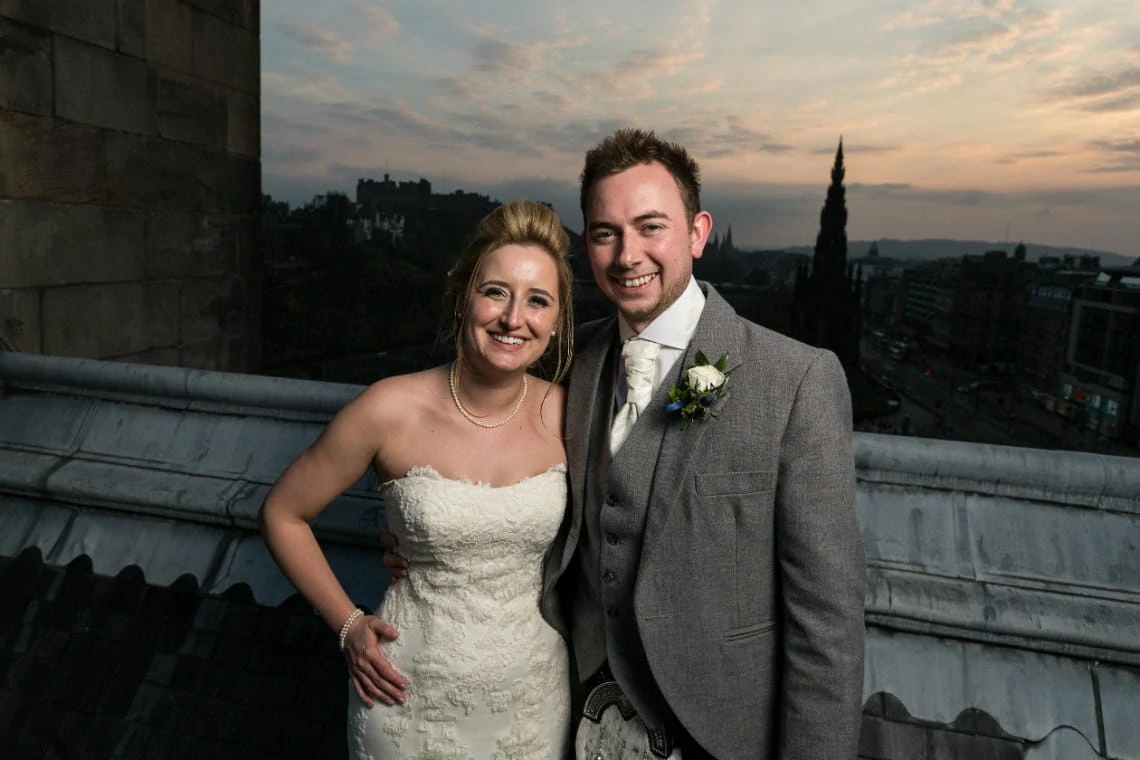 View From The Roof - newlyweds with Edinburgh Castle in the background