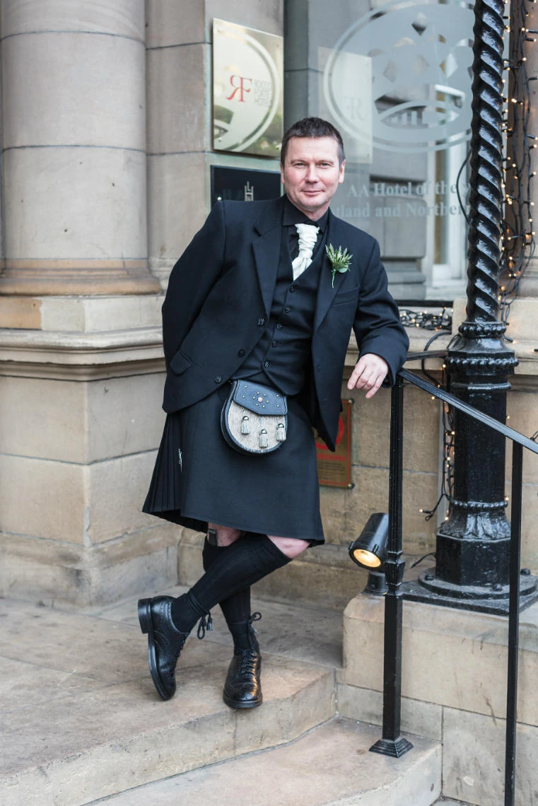 groom at the entrance to the Balmoral Hotel