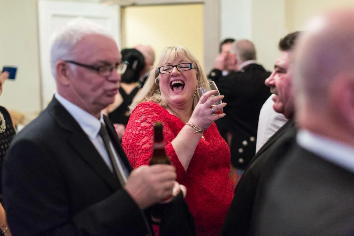 female guest laughing during drinks reception in the Waverley Suite