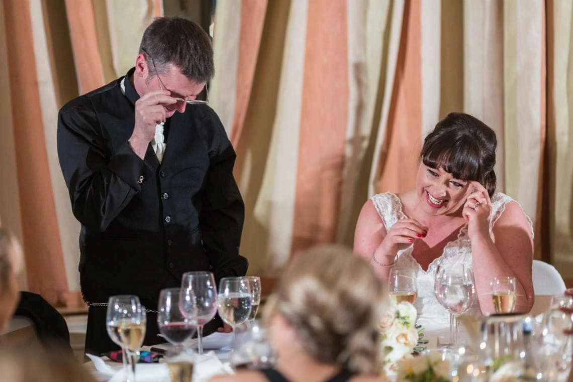 bride laughing during her husband's speech in the Beauly Suite