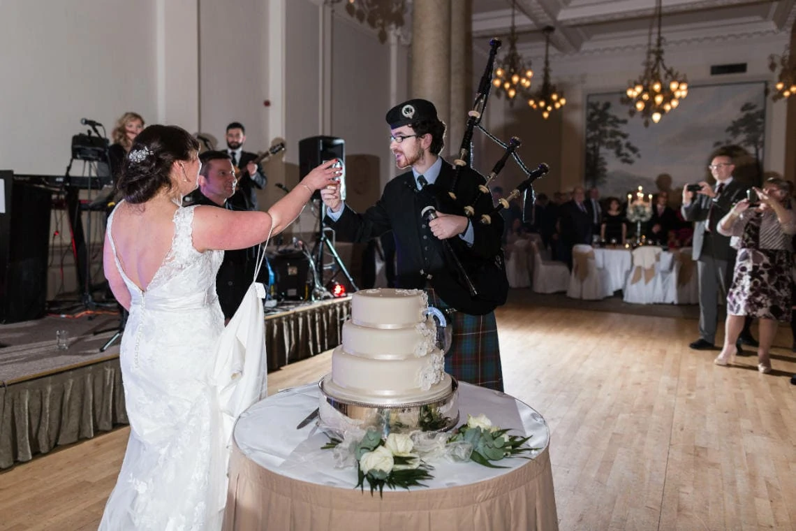 piper raises a toast to the newlyweds in the Sir Walter Scott Suite
