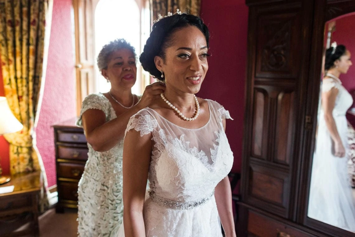 Bedroom - bride assisted by her mother