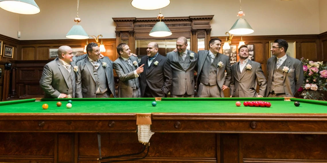 Billiards room groom and groomsmen laughing