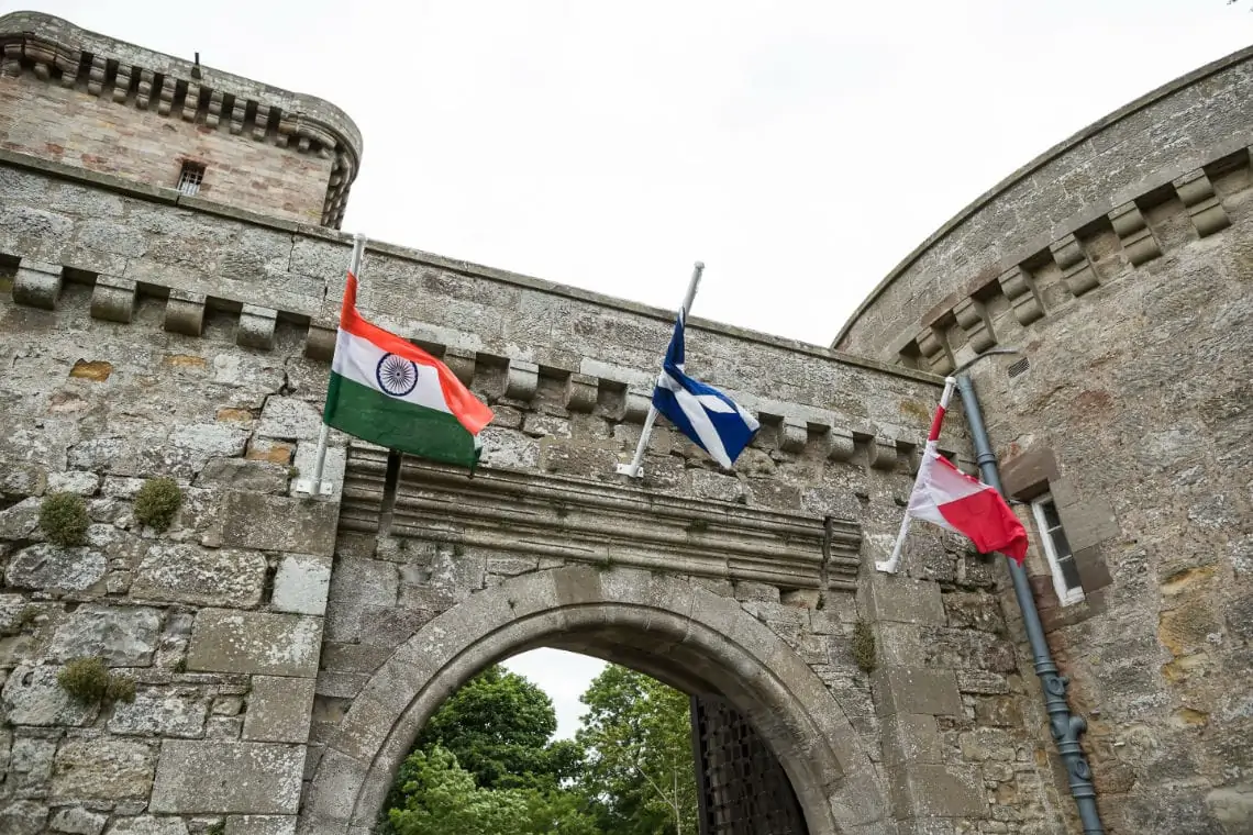 Indian, Scottish and Canadian flags at archway entrance