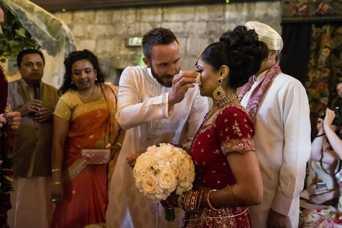 Man wipes away bride's tears with a tissue