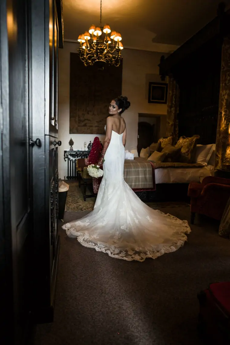 Bride looking over her shoulder wearing her dress