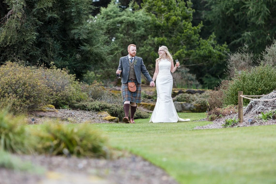 Botanic Gardens newlyweds-walking-across the grass holding hands