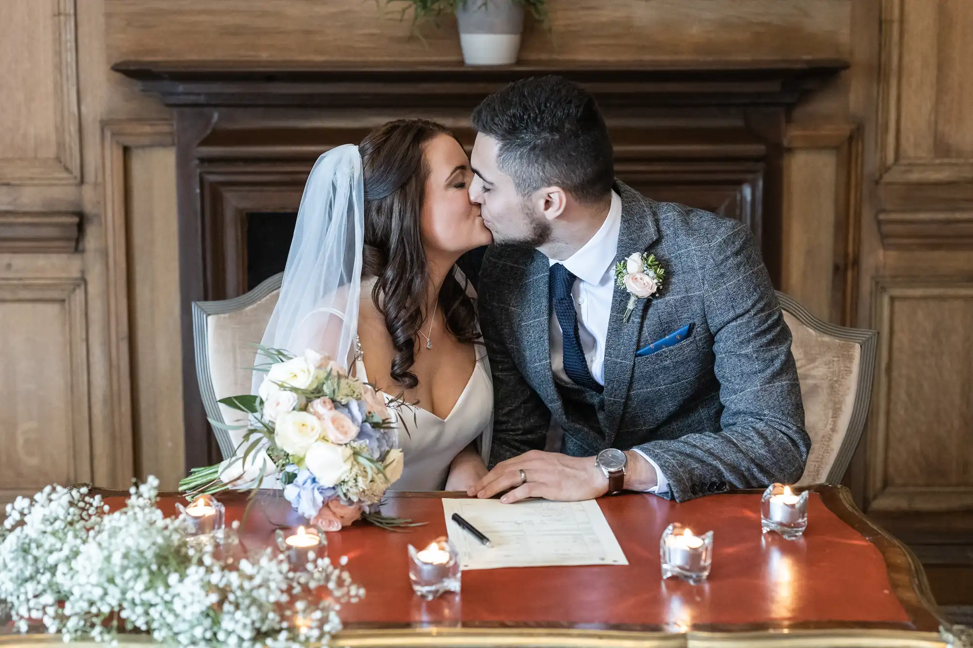 Newlyweds kiss each other after signing the marriage schedule