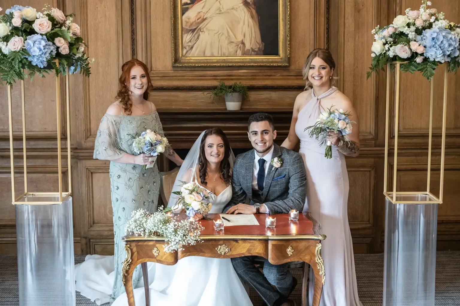 newlyweds and bridesmaids smiling at the camera