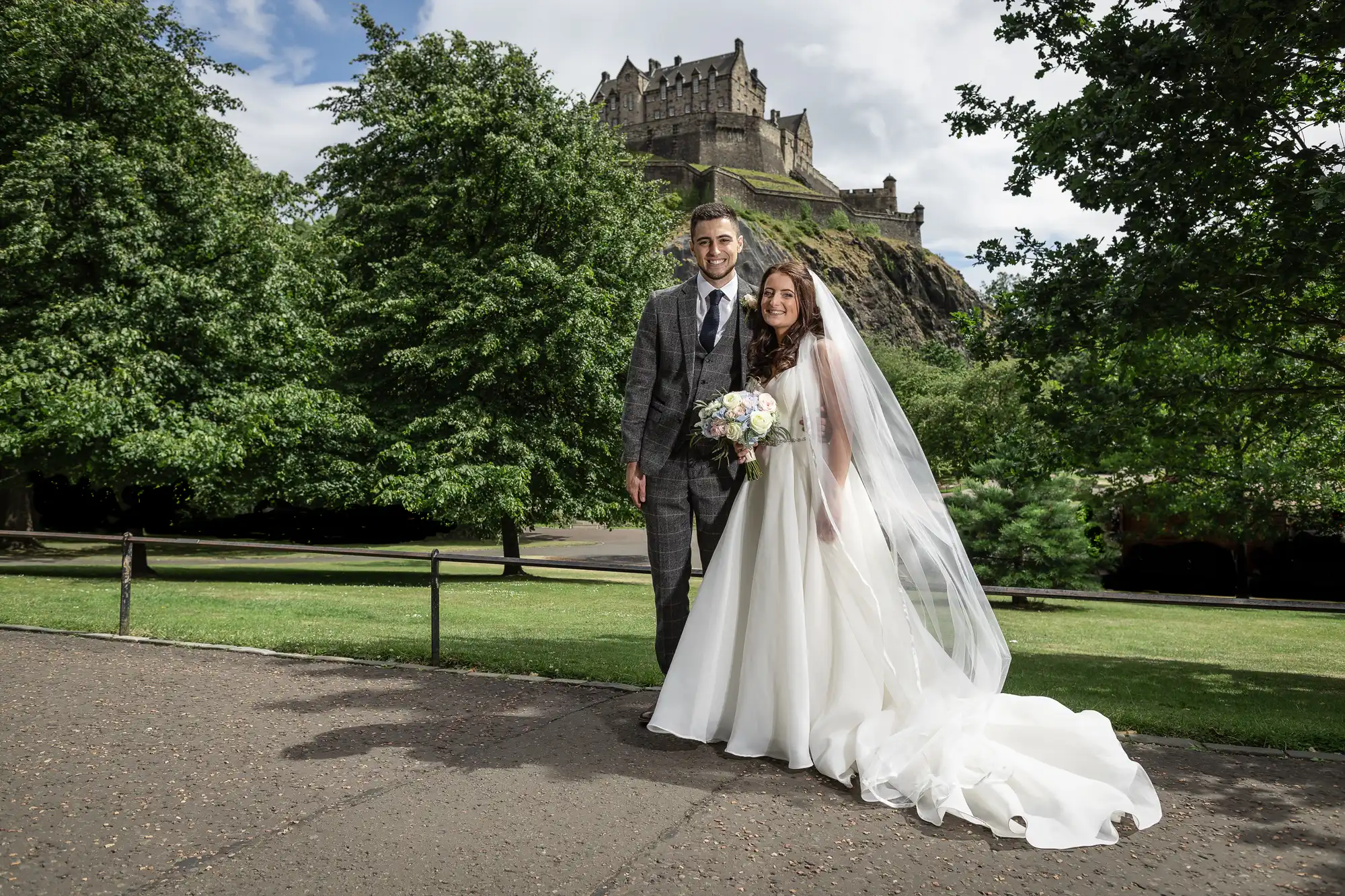 Newlyweds in Princes Street Gardens with Edinburgh Castle in the background