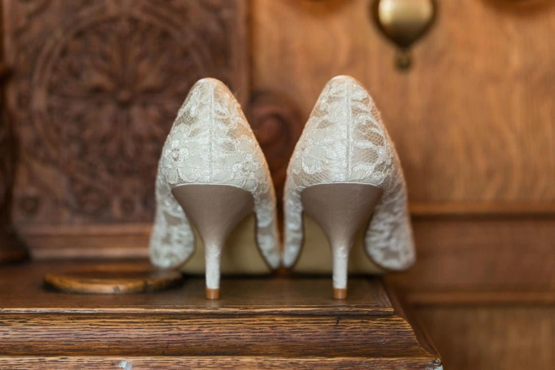 bride's white lace shoes view of the heels