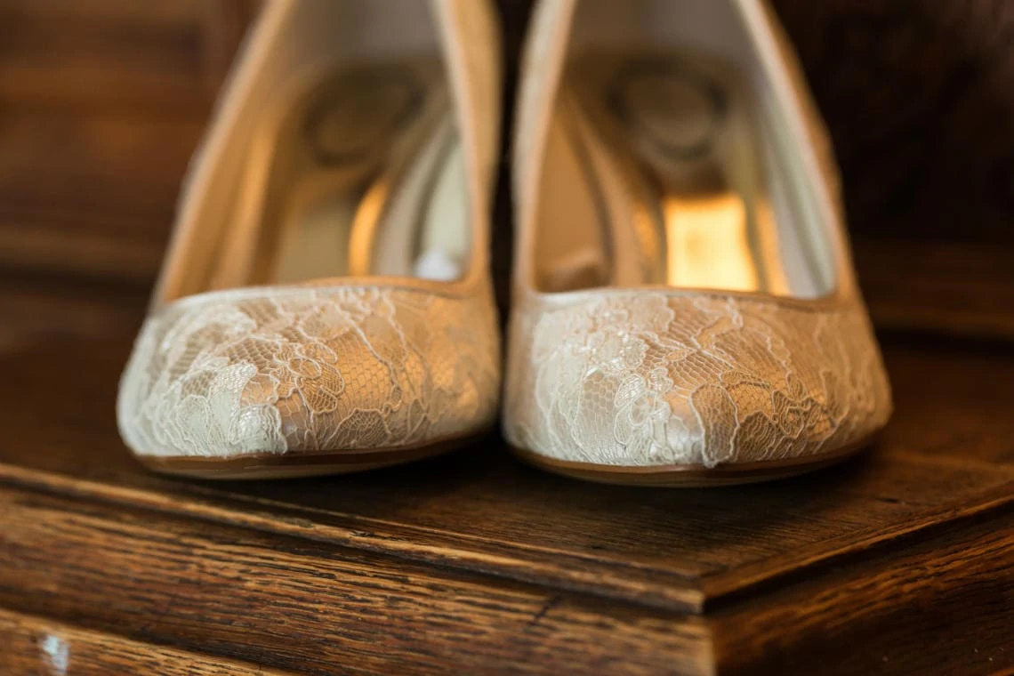 bride's lace shoes intricate details of the toes