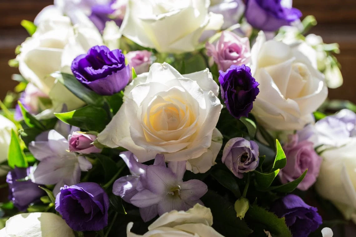 bridal bouquet white, purple and pink roses in The Library