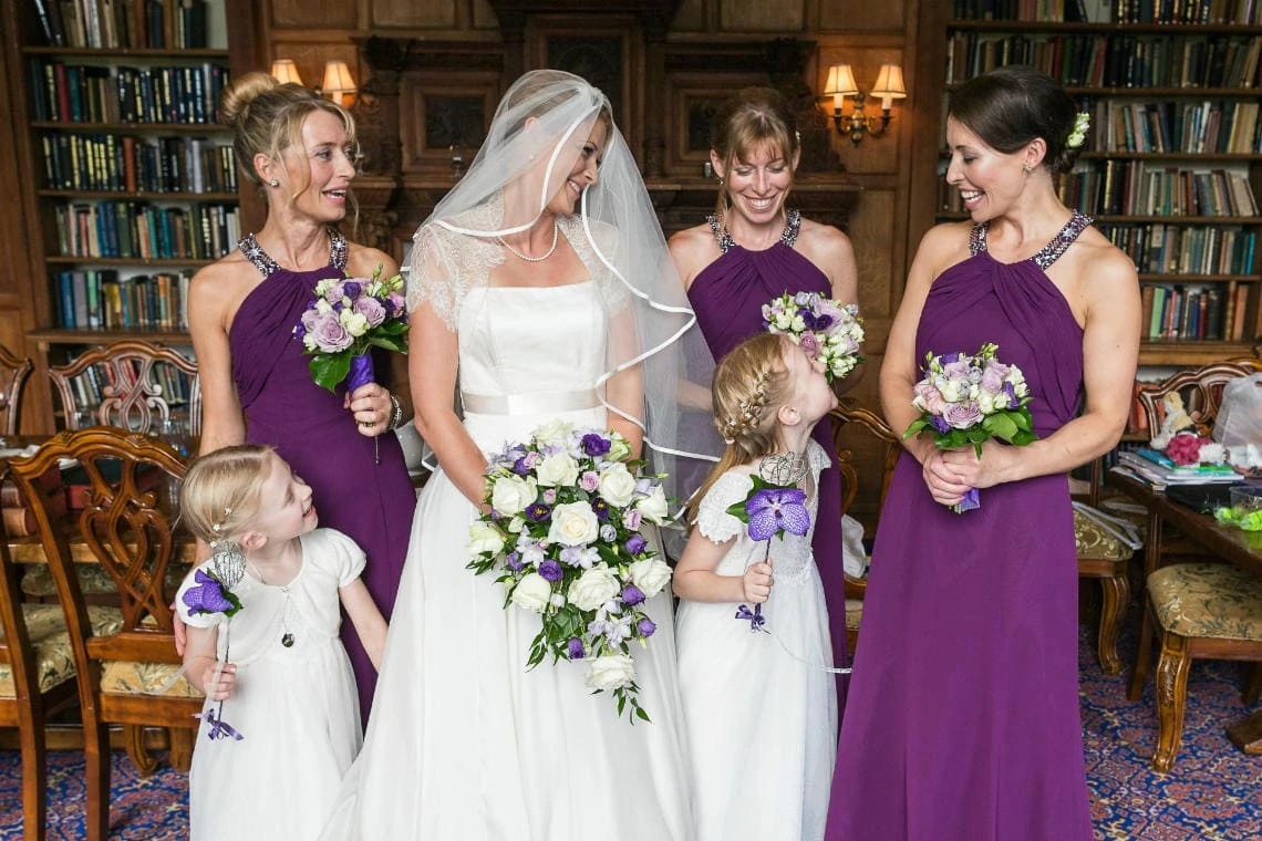 bride, bridesmaids and flowergirls in The Library ready for the ceremony