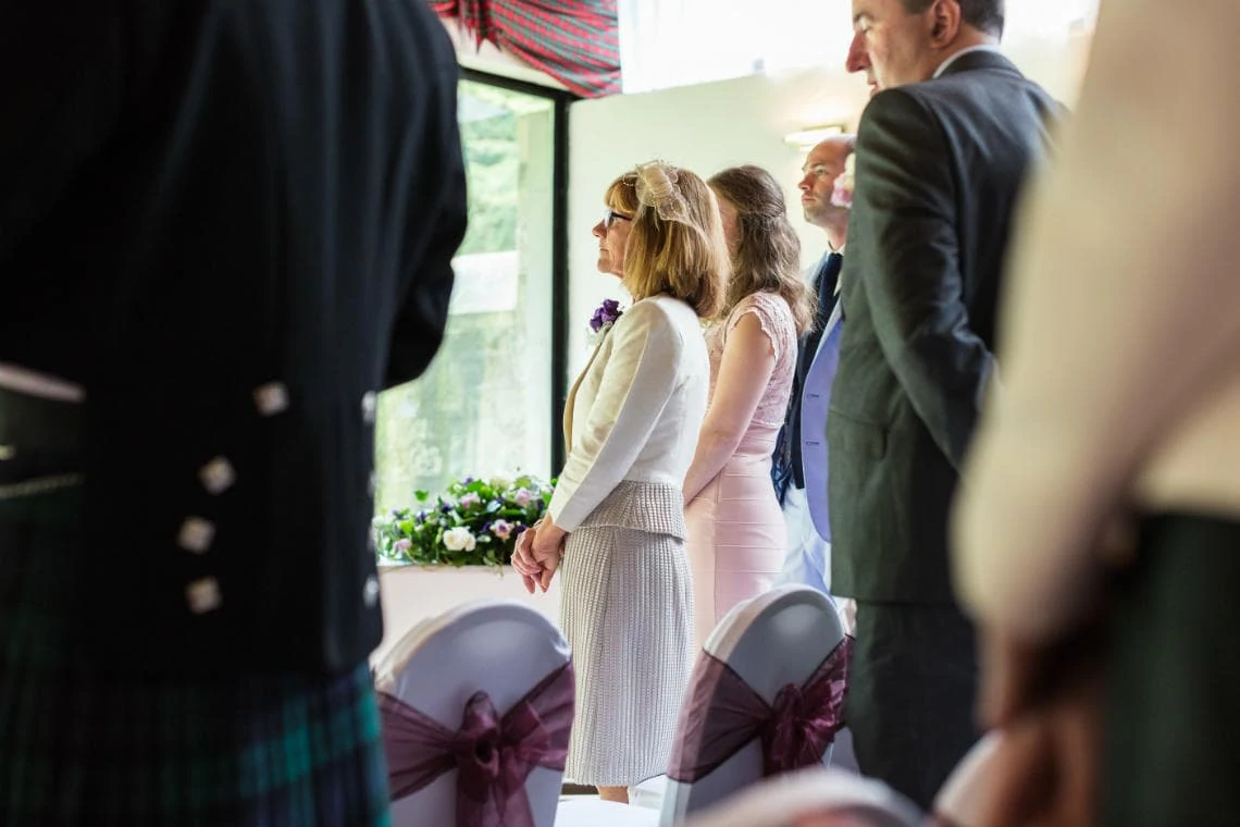 guests watching the exchange of rings and vows in the Chapel