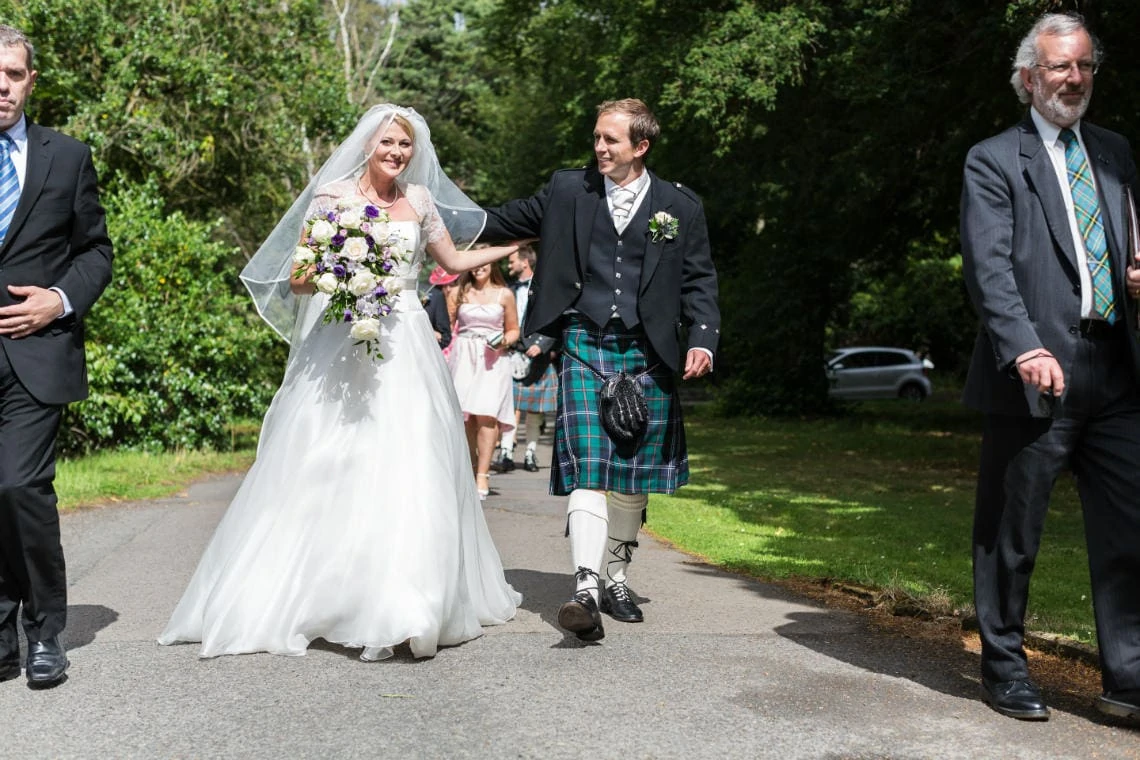 newlyweds walking from the Chapel to the Mansion House