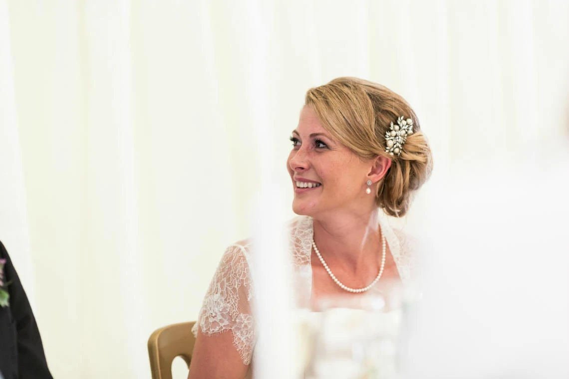 bride smiling during groom's speech in The Pavilion
