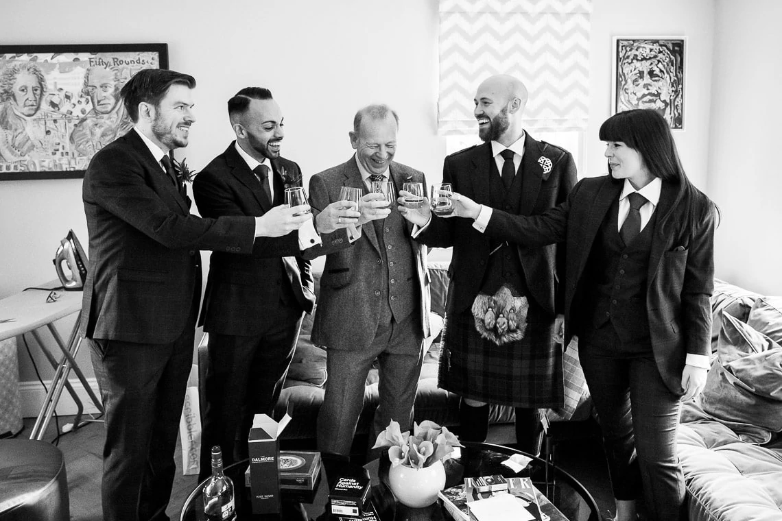 groom's party say cheers with whisky