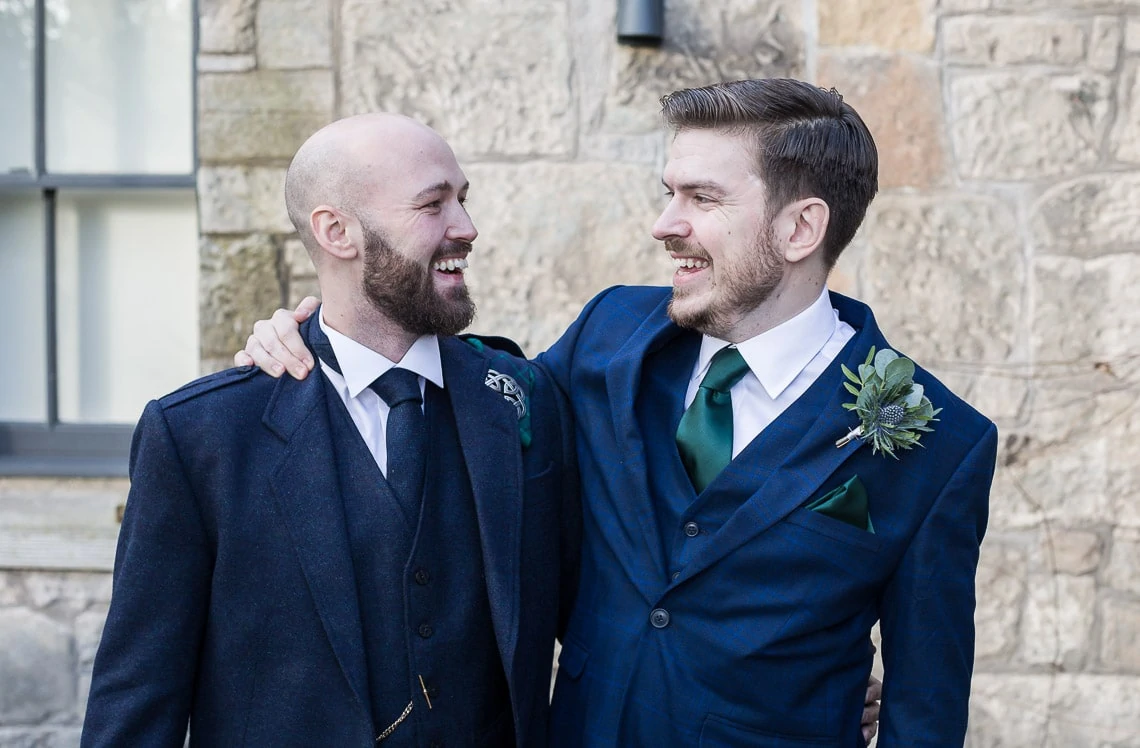 groom and best man laughing