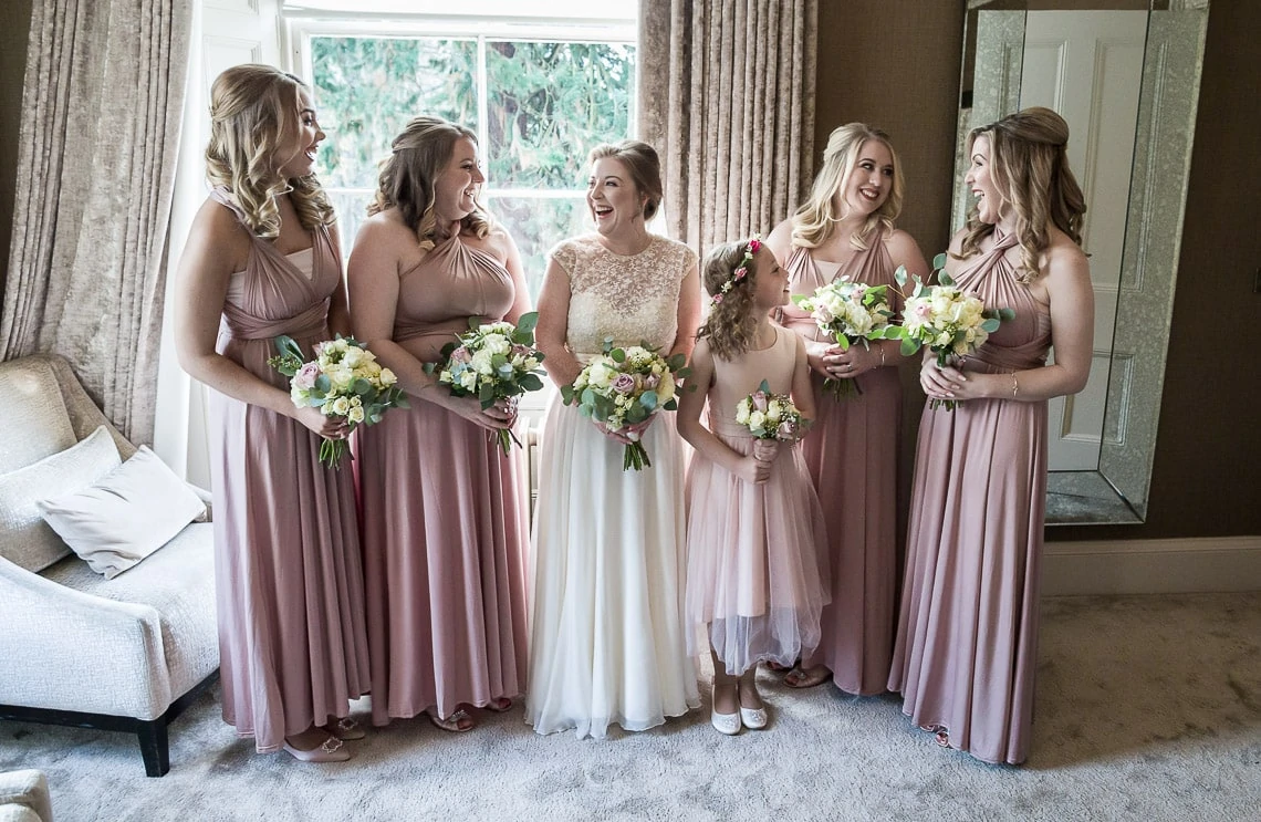 bride, bridesmaids and flower girl pre-ceremony group photo in bedroom